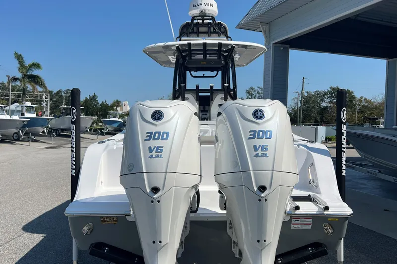 Slide: The Image of 2025 Sportsman Open 282 Center Console with twin 300 V6 engines at a marina. - 4