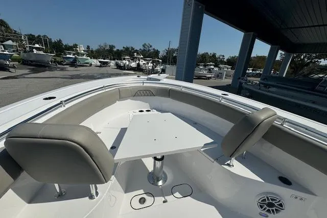 Slide: The Image of 2025 Sportsman Open 282 Center Console boat with seating and table in marina. - 7