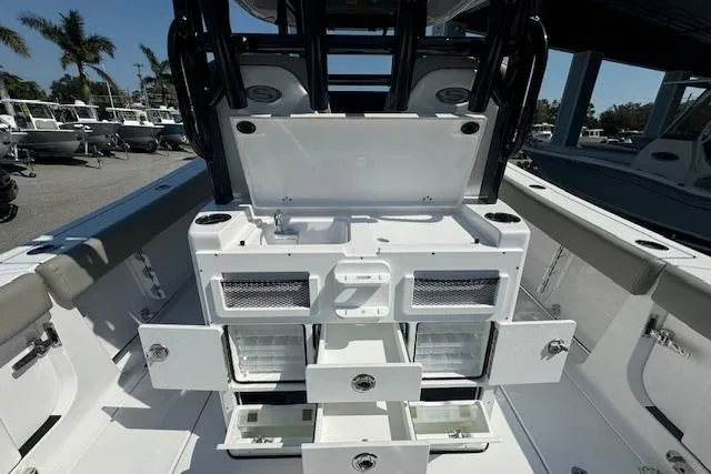 Slide: The Image of 2025 Sportsman Open 282 Center Console boat interior with storage compartments open. - 9