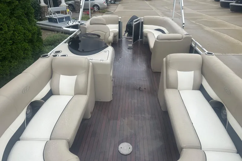 Slide: The Image of 2013 Harris Solstice 220 pontoon boat with beige seating and wood-style flooring. - 3