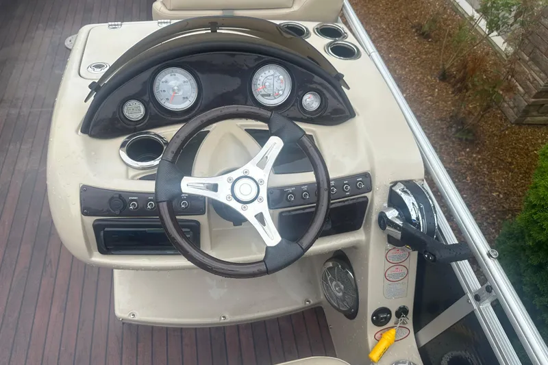 Slide: The Image of Steering console of a 2013 Harris Solstice 220 boat with gauges and controls. - 7