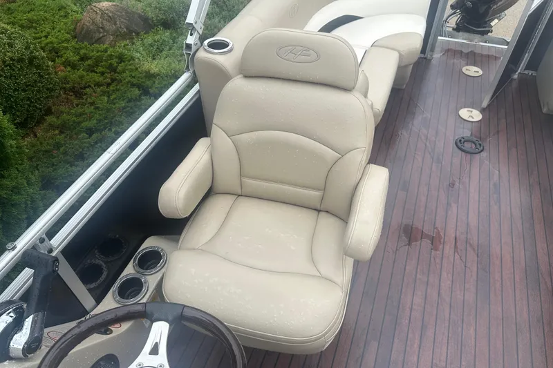 Slide: The Image of Luxurious seating on 2013 Harris Solstice 220 boat with elegant wood flooring. - 8