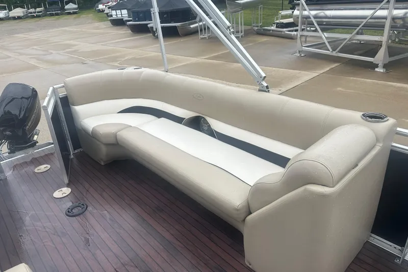 Slide: The Image of 2013 Harris Solstice 220 pontoon boat with beige seating and wooden deck. - 9