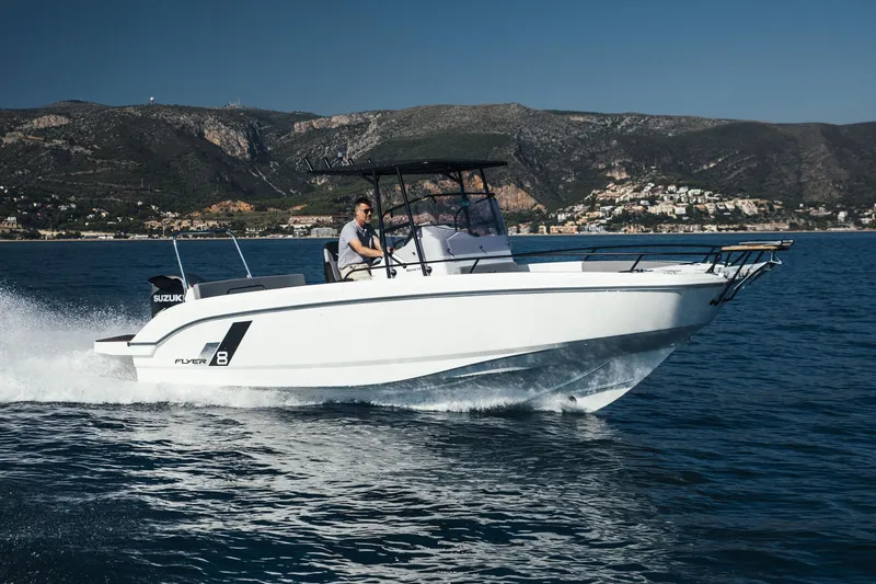 Slide: The Image of 2023 Beneteau Flyer 8 SPACEdeck cruising on open water with scenic mountain backdrop. - 22