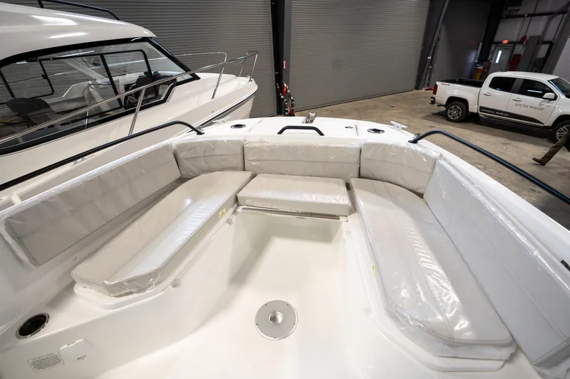 Slide: The Image of 2023 Beneteau Flyer 8 SPACEdeck boat interior with cushioned seating in a showroom. - 3