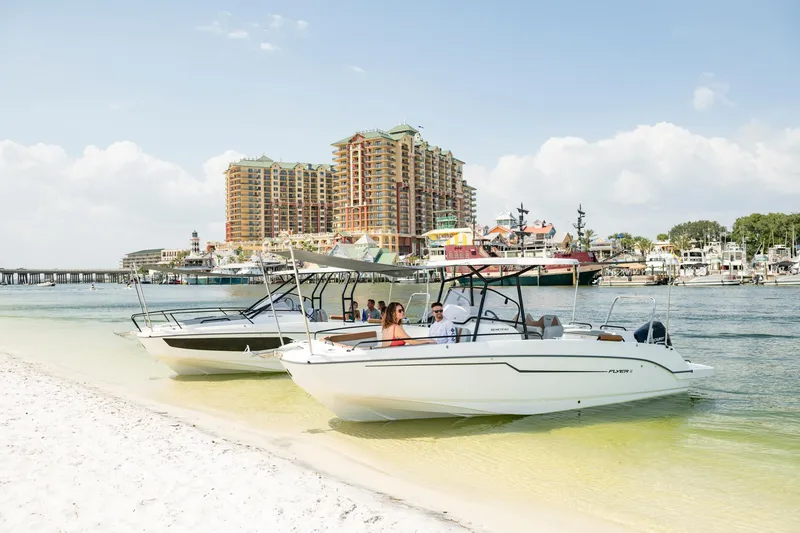 Slide: The Image of 2023 Beneteau Flyer 8 SPACEdeck boats on a sunny beach with cityscape background. - 24