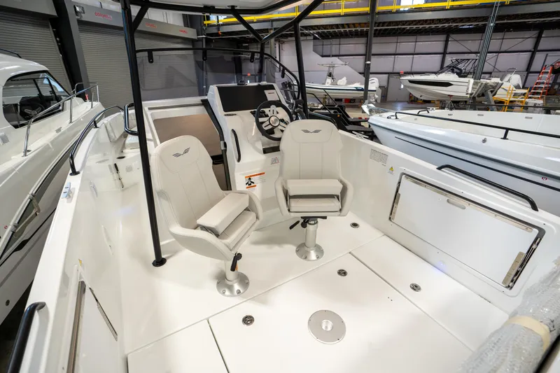 Slide: The Image of 2023 Beneteau Flyer 8 SPACEdeck interior with modern seating and control panel in a showroom. - 6
