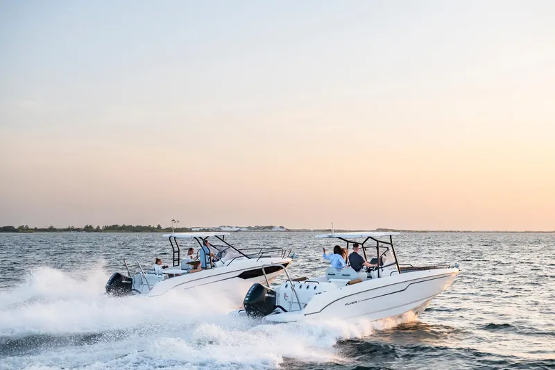 Slide: The Image of 2023 Beneteau Flyer 8 SPACEdeck boats cruising on open water at sunset. - 25