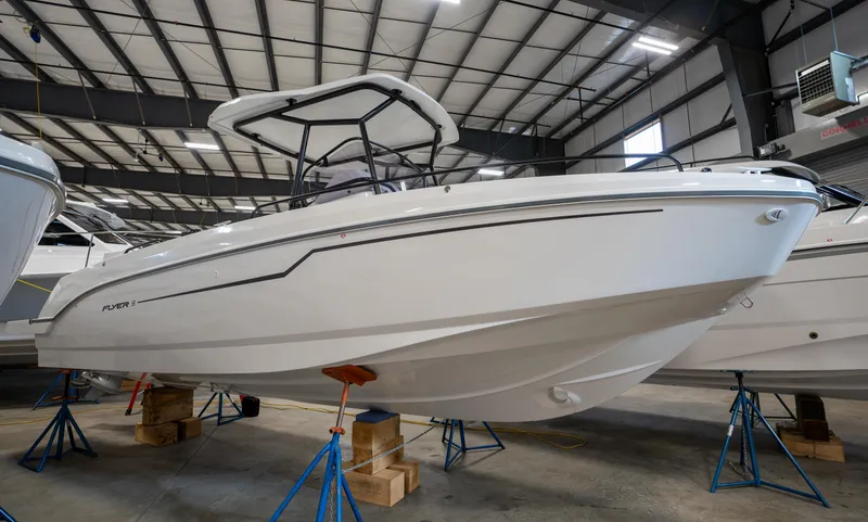 Slide: The Image of 2023 Beneteau Flyer 8 SPACEdeck boat in a showroom, elevated on stands. - 2
