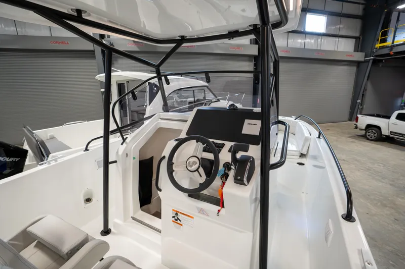Slide: The Image of 2023 Beneteau Flyer 8 SPACEdeck boat interior with steering console in a showroom. - 4