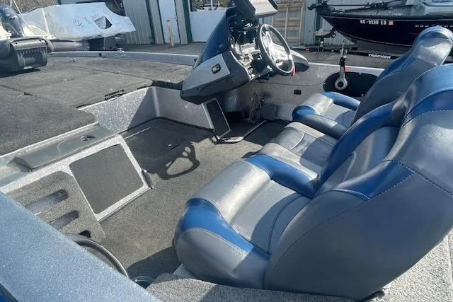 Slide: The Image of 2012 Skeeter ZX20 boat interior with blue and gray seating and steering console. - 6