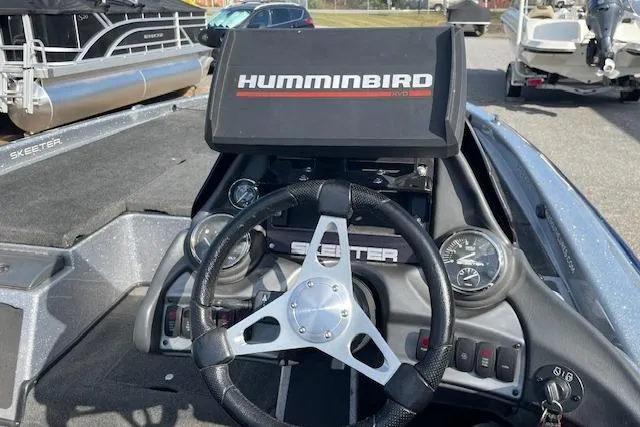 Slide: The Image of 2012 Skeeter ZX20 boat dashboard with Humminbird GPS and steering wheel. - 8