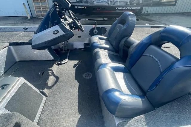 Slide: The Image of 2012 Skeeter ZX20 boat interior with blue and gray seating, steering console visible. - 9