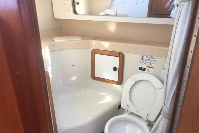 Slide: The Image of 2001 Catalina 34 Mk II yacht bathroom with toilet and storage cabinet. - 10