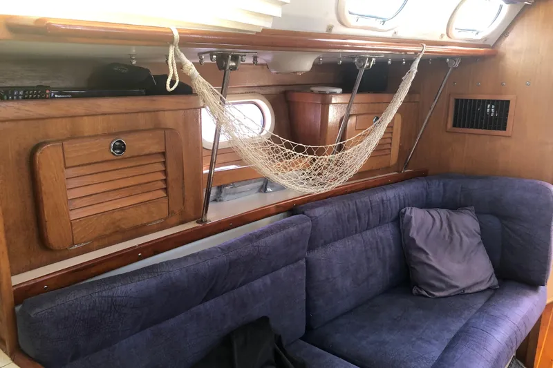Slide: The Image of Interior of a 2001 Catalina 34 Mk II sailboat with blue seating and wooden cabinetry. - 13