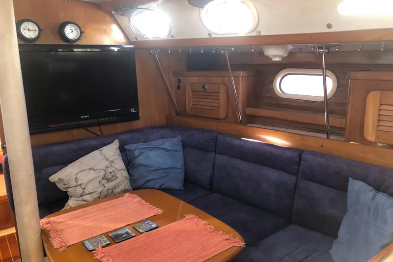 Slide: The Image of Interior of 2001 Catalina 34 Mk II sailboat with cozy seating and TV. - 14
