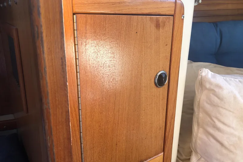 Slide: The Image of Wooden cabinet door inside a 2001 Catalina 34 Mk II sailboat interior. - 17
