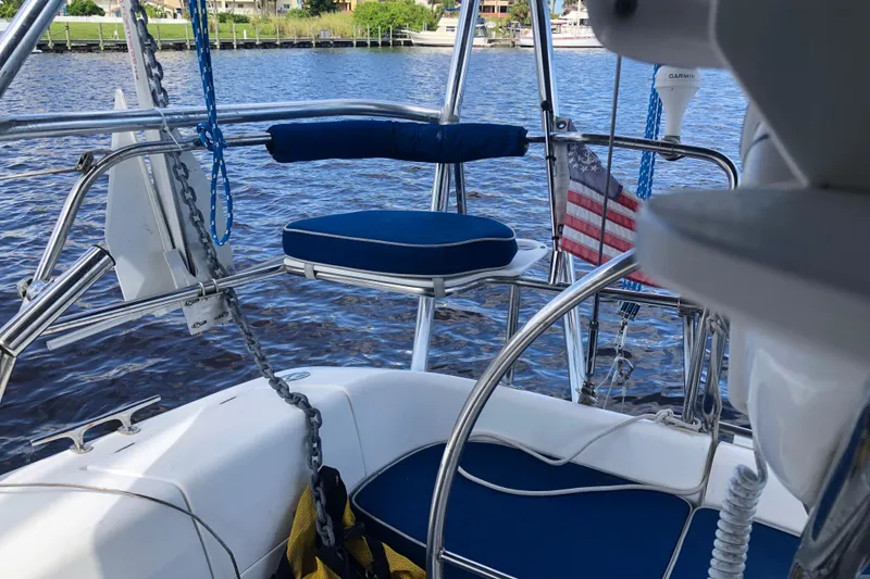 Slide: The Image of 2001 Catalina 34 Mk II sailboat cockpit with blue seating and American flag. - 4