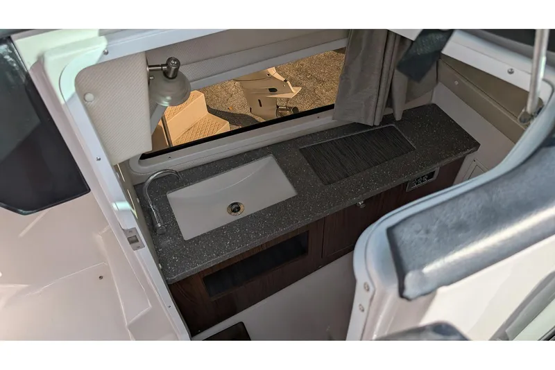 Slide: The Image of 2019 Four Winns H290 OB boat interior with sink and countertop. - 16