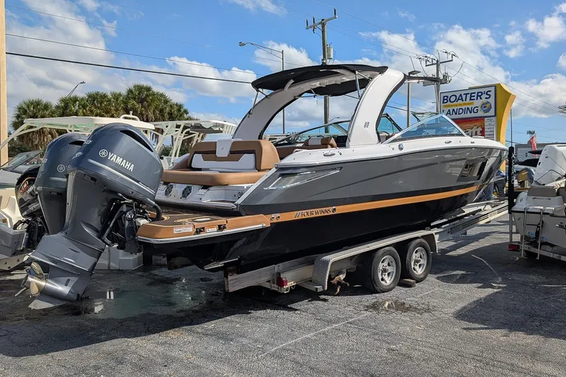 Slide: The Image of 2019 Four Winns H290 OB boat with Yamaha outboard engines on a trailer. - 2
