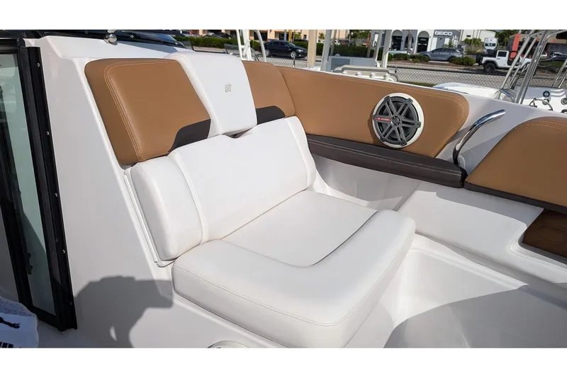 Slide: The Image of 2019 Four Winns H290 OB boat interior with white and brown seating, featuring a speaker. - 22