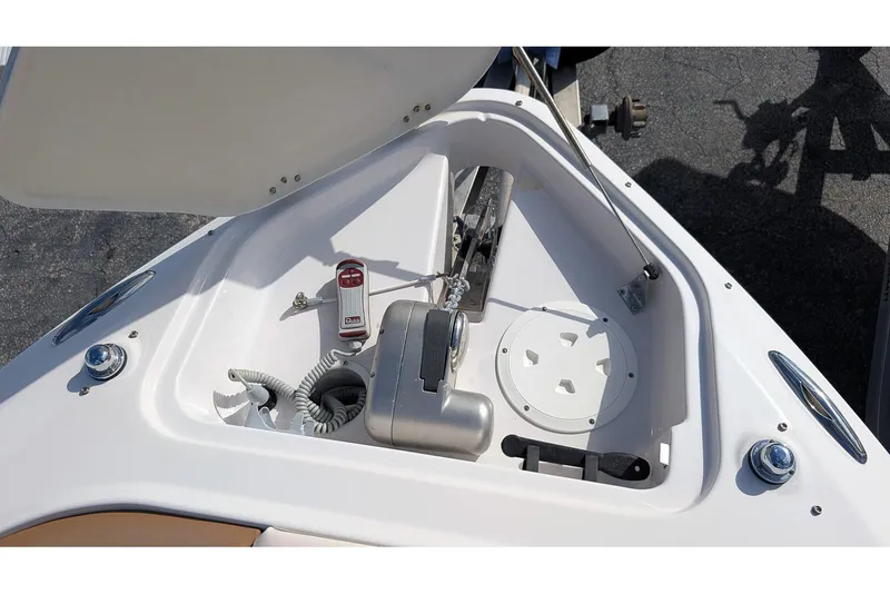 Slide: The Image of 2019 Four Winns H290 OB boat anchor compartment with winch and control panel. - 23