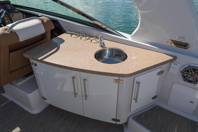 Slide: The Image of Manufacturer Provided Image: 2019 Four Winns Horizon H290 OB boat interior with sink and storage cabinets. - 36