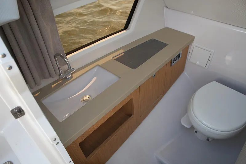 Slide: The Image of Manufacturer Provided Image: 2019 Four Winns Horizon H290 OB boat bathroom with sink, toilet, and window. - 38