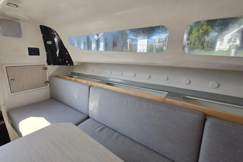 Slide: The Image of Interior of 2022 Corsair 880 Sport sailboat with seating and windows. - 14