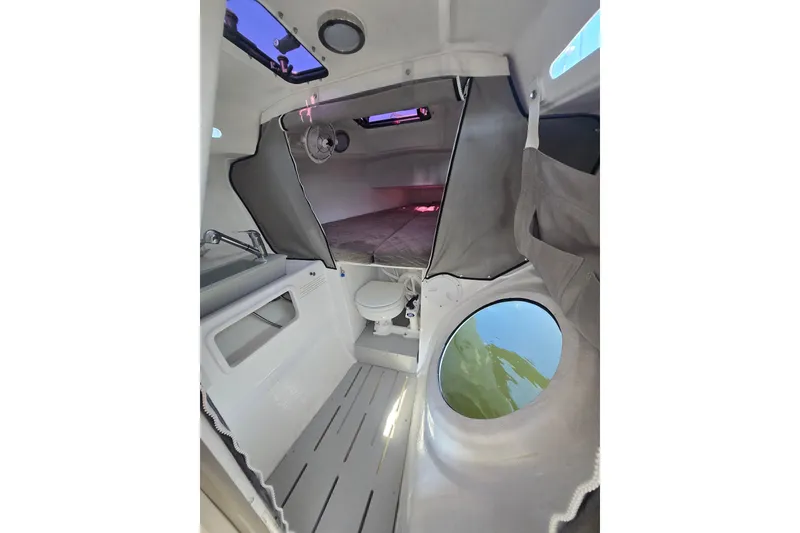 Slide: The Image of Interior of 2022 Corsair 880 Sport sailboat, featuring compact cabin amenities. - 19