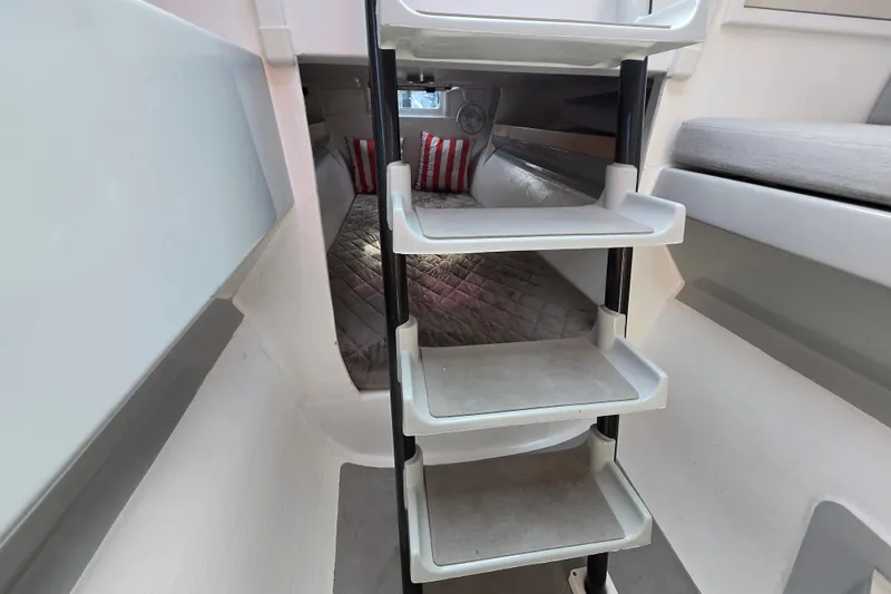 Slide: The Image of Interior of 2022 Corsair 880 Sport boat, featuring compact cabin and ladder. - 20