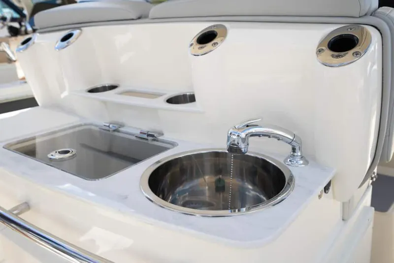 Slide: The Image of Manufacturer Provided Image: 2025 Scout 305 LXF boat sink and prep station with stainless steel fixtures. - 10