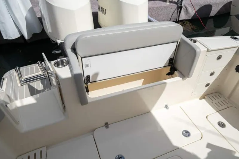 Slide: The Image of Manufacturer Provided Image: 2025 Scout 305 LXF boat interior with storage compartment and seating. - 11