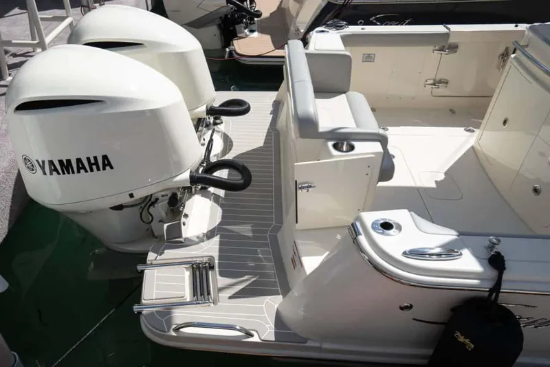 Slide: The Image of Manufacturer Provided Image: 2025 Scout 305 LXF boat with Yamaha engines, featuring a sleek deck and seating area. - 12