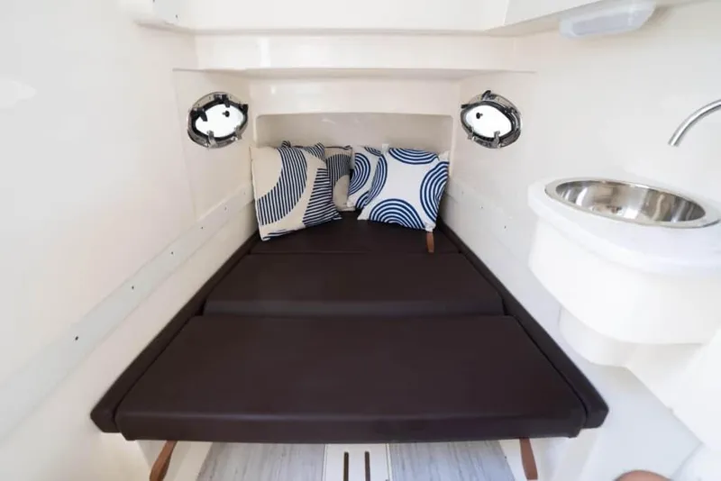 Slide: The Image of Manufacturer Provided Image: 2025 Scout 305 LXF cabin interior with bed, pillows, and sink. - 13