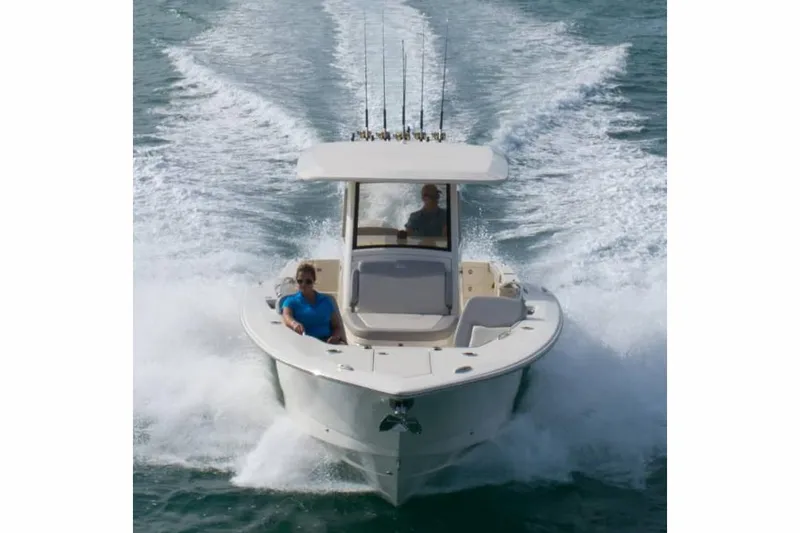 Slide: The Image of Manufacturer Provided Image: 2025 Scout 305 LXF boat cruising on open water, featuring fishing rods. - 2