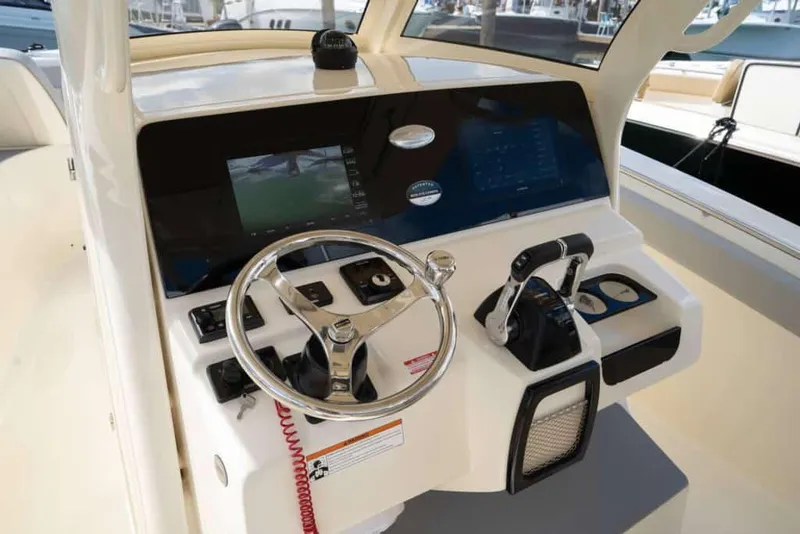 Slide: The Image of Manufacturer Provided Image: 2025 Scout 305 LXF boat dashboard with steering wheel and controls. - 8