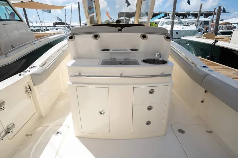 Slide: The Image of Manufacturer Provided Image: 2025 Scout 305 LXF boat interior with sink and storage cabinets. - 9