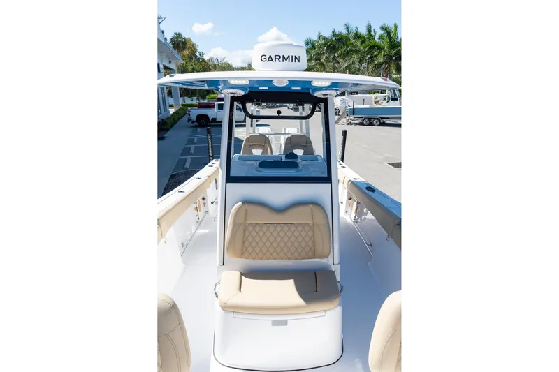 Slide: The Image of 2026 Sportsman Open 282 Center Console boat with Garmin equipment, docked under clear skies. - 11