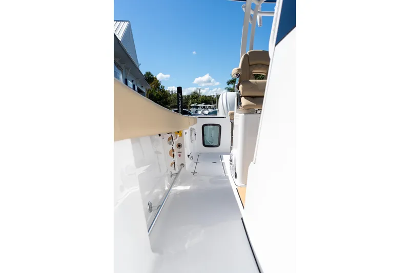 Slide: The Image of 2026 Sportsman Open 282 Center Console boat, sleek deck view under clear blue sky. - 14