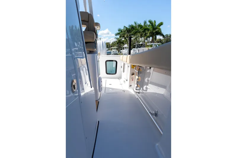 Slide: The Image of 2026 Sportsman Open 282 Center Console boat interior with seating and rod holders. - 15