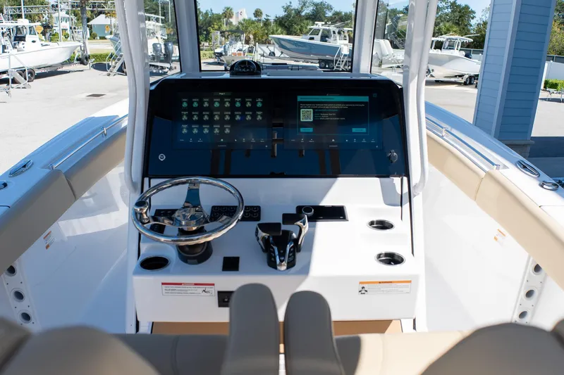 Slide: The Image of 2026 Sportsman Open 282 Center Console boat dashboard with modern controls and touchscreen display. - 25