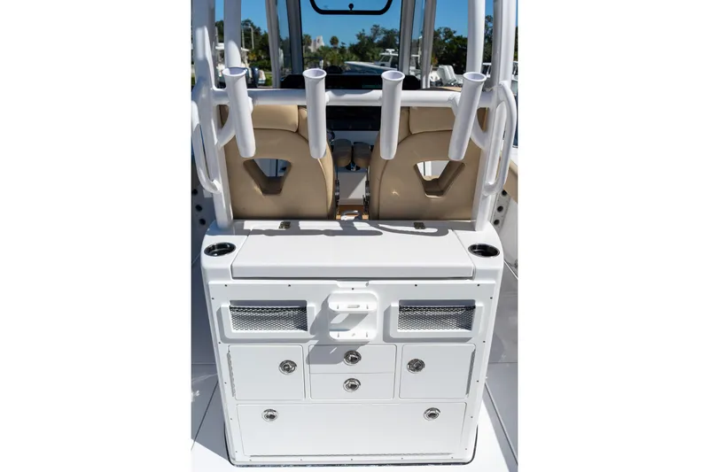 Slide: The Image of 2026 Sportsman Open 282 Center Console boat interior with rod holders and storage compartments. - 27