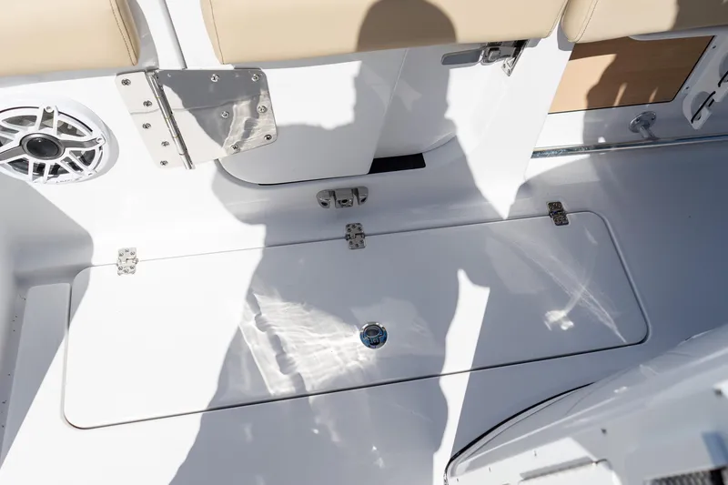 Slide: The Image of 2026 Sportsman Open 282 Center Console boat deck with storage hatch and speaker. - 37