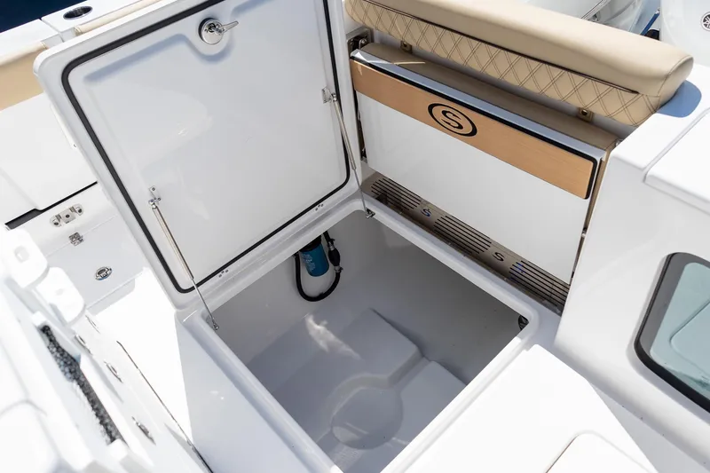 Slide: The Image of 2026 Sportsman Open 282 Center Console storage compartment with open lid and cushioned seating. - 39