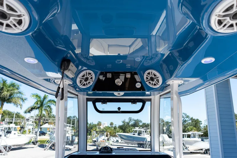 Slide: The Image of 2026 Sportsman Open 282 Center Console boat interior with blue ceiling and speakers. - 40