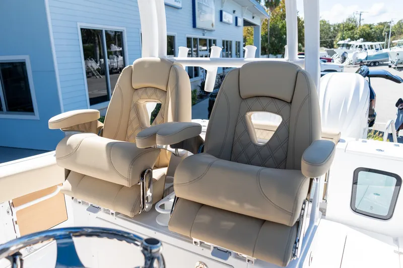 Slide: The Image of 2026 Sportsman Open 282 Center Console boat seats, featuring luxurious beige upholstery. - 44