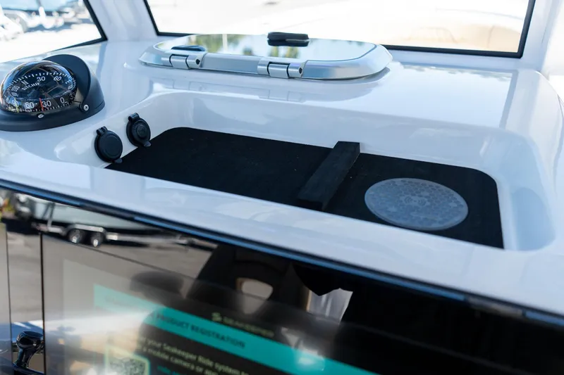 Slide: The Image of 2026 Sportsman Open 282 Center Console dashboard with compass and controls. - 47