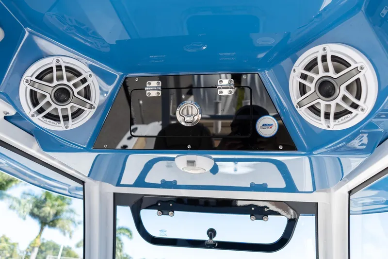 Slide: The Image of 2026 Sportsman Open 282 Center Console with JL Audio speakers and blue interior. - 48