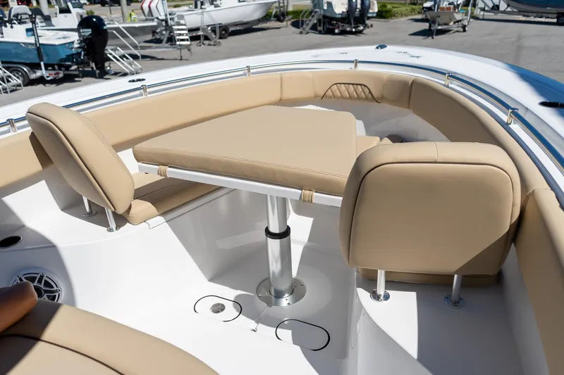 Slide: The Image of 2026 Sportsman Open 282 Center Console boat with beige seating and table in the bow area. - 52